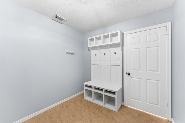 4103 Waterstone Dr, Missouri City, TX 77459 - mudroom with a textured ceiling, baseboards, visible vents, and light tile patterned floors