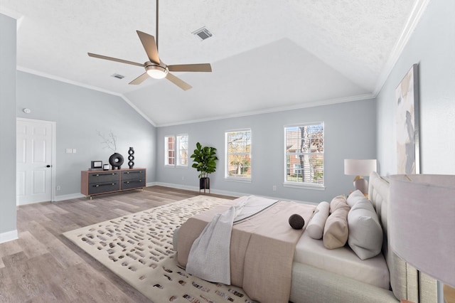 4103 Waterstone Dr, Missouri City, TX 77459 - bedroom featuring visible vents, ornamental molding, light wood finished floors, and lofted ceiling