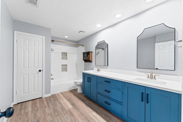 4103 Waterstone Dr, Missouri City, TX 77459 - bathroom with visible vents, a sink, wood finished floors, and toilet
