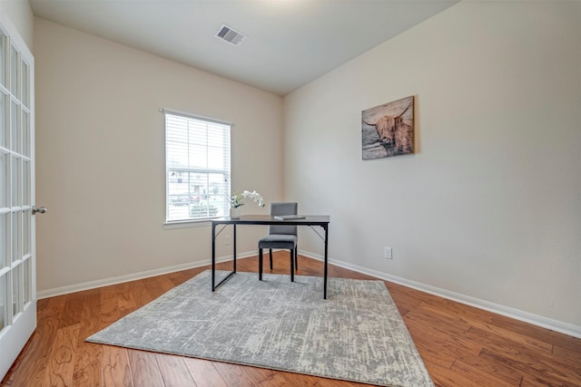 7908 Beryl Ct, Texas City, TX 77591 - home office with baseboards, wood finished floors, and visible vents