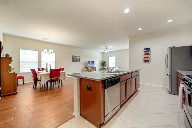 7908 Beryl Ct, Texas City, TX 77591 - kitchen featuring stainless steel appliances, a healthy amount of sunlight, a sink, and a center island with sink