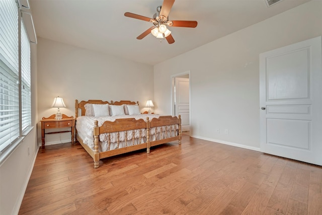 7908 Beryl Ct, Texas City, TX 77591 - bedroom with light wood-style floors, baseboards, ceiling fan, and visible vents