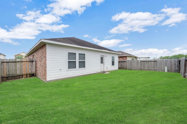 7908 Beryl Ct, Texas City, TX 77591 - back of house with a yard, brick siding, and a fenced backyard
