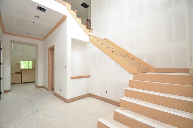 stairway featuring baseboards