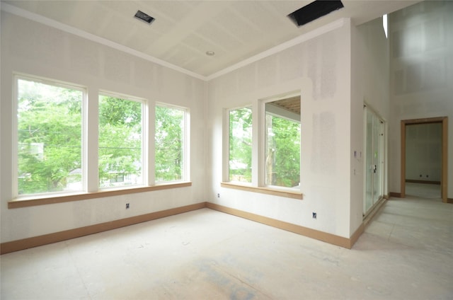 unfurnished room with baseboards and visible vents