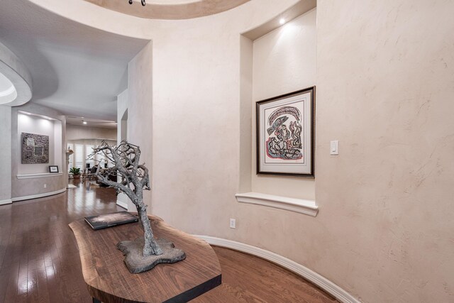 hallway featuring baseboards and wood finished floors