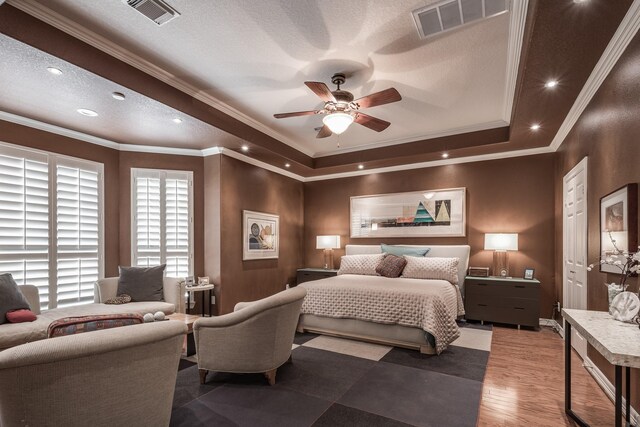bedroom featuring crown molding, recessed lighting, a raised ceiling, and visible vents