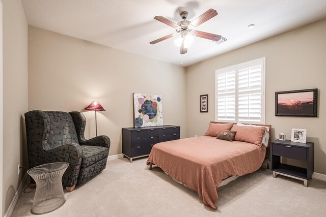 bedroom featuring light colored carpet, a ceiling fan, baseboards, and visible vents