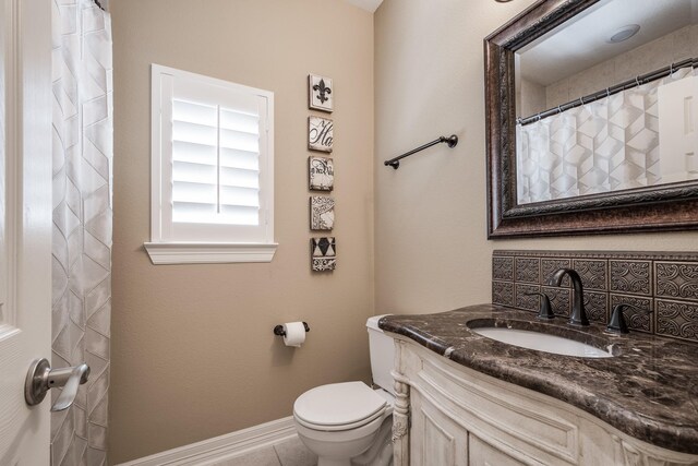 full bathroom with vanity, tile patterned flooring, toilet, baseboards, and a shower with shower curtain