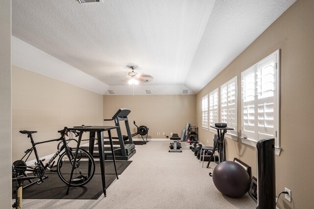 workout area with ceiling fan, carpet, baseboards, vaulted ceiling, and visible vents