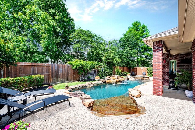 view of swimming pool with a fenced backyard, a fenced in pool, and a patio area