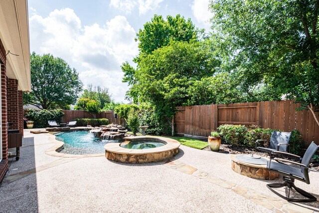 view of swimming pool with a fenced backyard, a fenced in pool, a patio, and an in ground hot tub