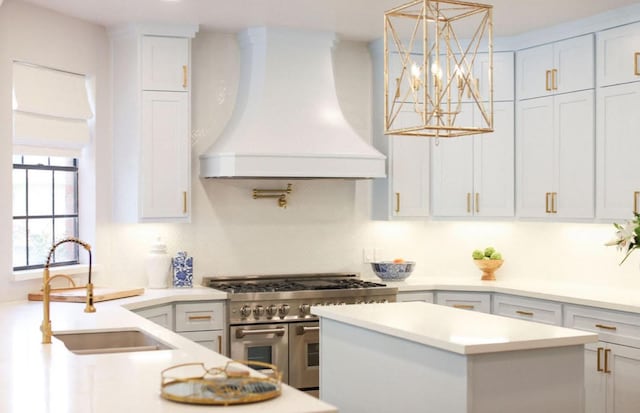 32743 Weybridge St, Fulshear, TX 77441 - kitchen with custom exhaust hood, double oven range, light countertops, a center island, and decorative light fixtures