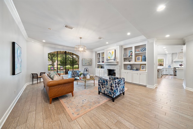 32743 Weybridge St, Fulshear, TX 77441 - living area featuring crown molding, plenty of natural light, light wood-style flooring, recessed lighting, and a brick fireplace