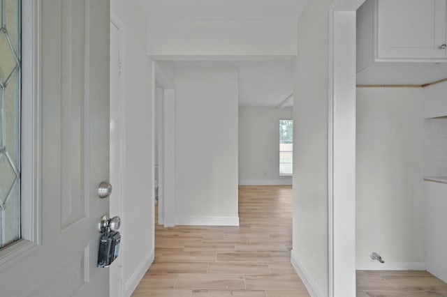 entrance foyer featuring baseboards and light wood-style flooring