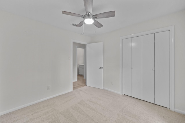 unfurnished bedroom with carpet floors, baseboards, a closet, and visible vents