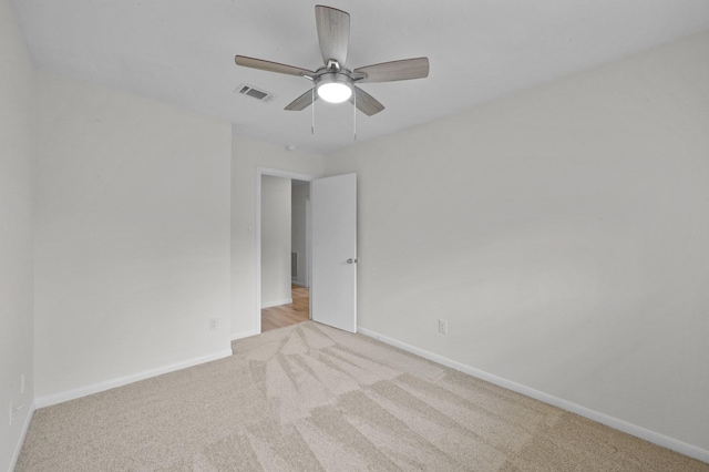 spare room featuring visible vents, a ceiling fan, baseboards, and carpet floors