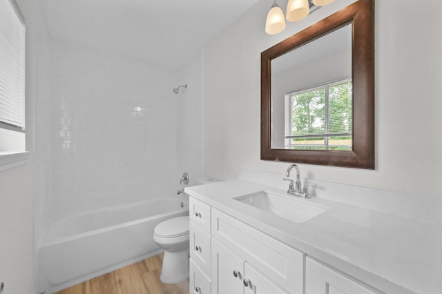 bathroom with vanity, shower / bathing tub combination, wood finished floors, and toilet
