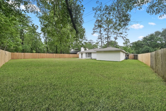 view of yard with a fenced backyard