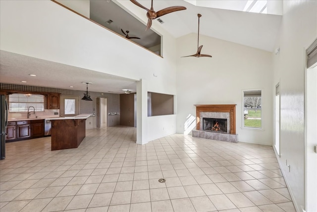 3139 Fm 1406, Winnie, TX 77665 - unfurnished living room with a high end fireplace, a sink, a ceiling fan, and light tile patterned floors