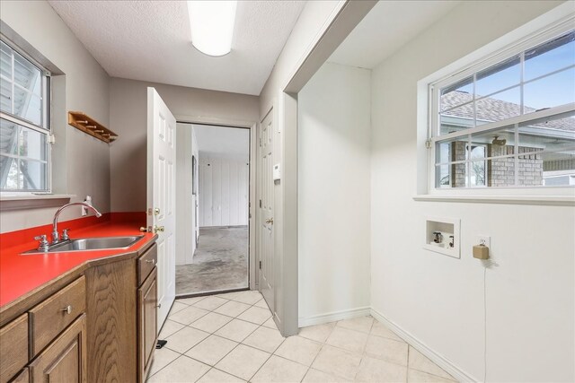 3139 Fm 1406, Winnie, TX 77665 - laundry area featuring cabinet space, a healthy amount of sunlight, a sink, and hookup for a washing machine