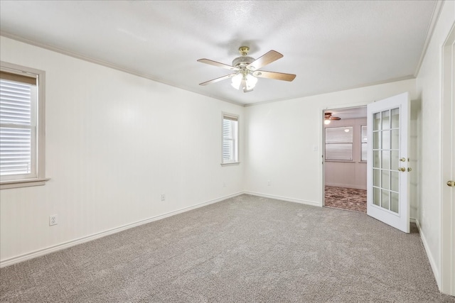 3139 Fm 1406, Winnie, TX 77665 - carpeted empty room with baseboards, a ceiling fan, french doors, and ornamental molding
