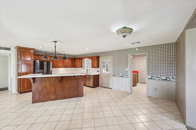 3139 Fm 1406, Winnie, TX 77665 - kitchen with stainless steel dishwasher, visible vents, fridge with ice dispenser, and light countertops