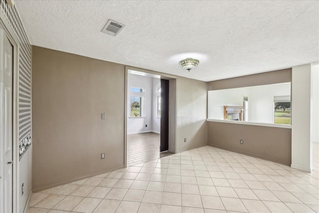 3139 Fm 1406, Winnie, TX 77665 - spare room with light tile patterned floors, baseboards, a textured ceiling, and visible vents