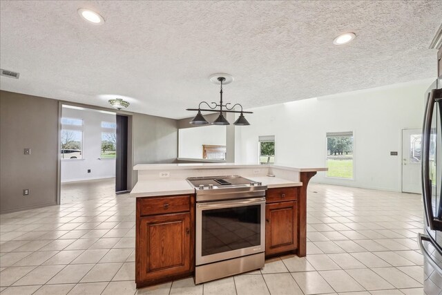 3139 Fm 1406, Winnie, TX 77665 - kitchen featuring light tile patterned floors, light countertops, electric range, and open floor plan