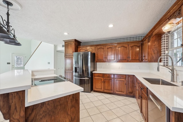 3139 Fm 1406, Winnie, TX 77665 - kitchen with a kitchen island, a textured ceiling, a sink, stainless steel appliances, and light tile patterned flooring