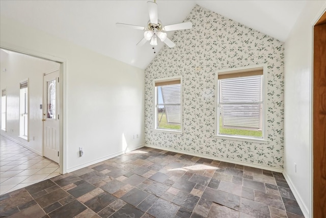 3139 Fm 1406, Winnie, TX 77665 - spare room featuring baseboards, a ceiling fan, wallpapered walls, and lofted ceiling