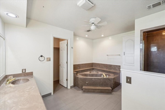 3139 Fm 1406, Winnie, TX 77665 - full bath with vanity, a ceiling fan, a garden tub, and visible vents