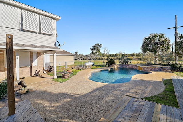 3139 Fm 1406, Winnie, TX 77665 - view of pool with fence, a pool with connected hot tub, and a patio area