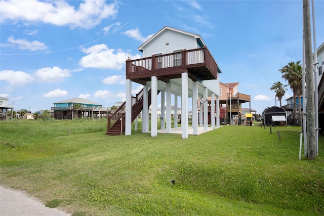 exterior space featuring a wooden deck, stairs, and a yard
