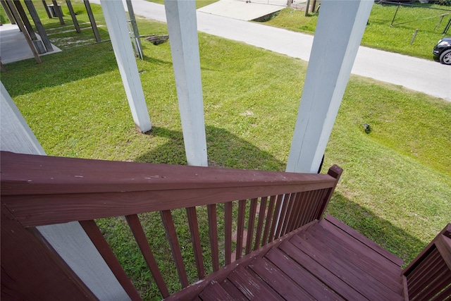 wooden terrace featuring a yard
