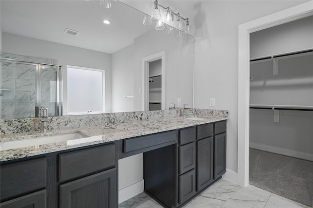 23415 Persimmon Creek Ln, Katy, TX 77493 - bathroom with visible vents, a shower stall, a sink, and marble finish floor