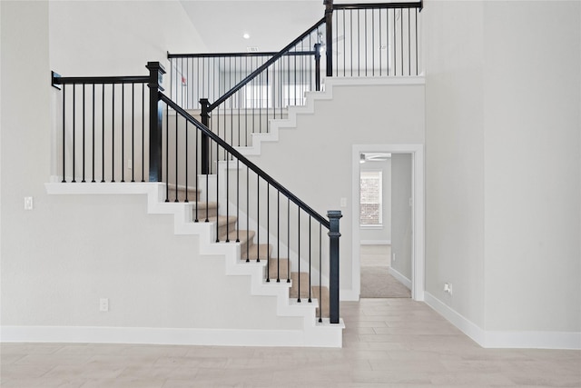 23415 Persimmon Creek Ln, Katy, TX 77493 - staircase featuring a ceiling fan, wood finished floors, and a towering ceiling