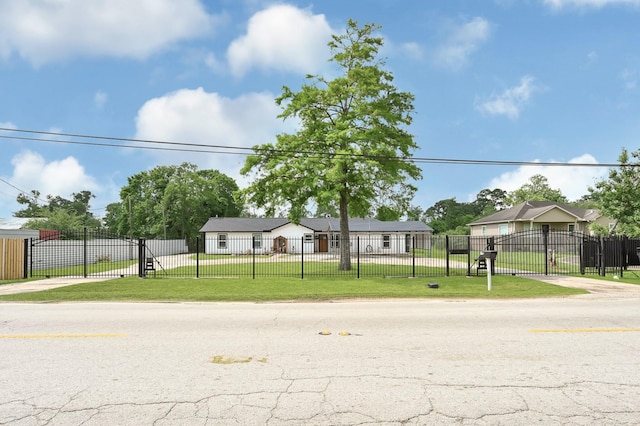 manufactured / mobile home featuring fence, a gate, and a front yard