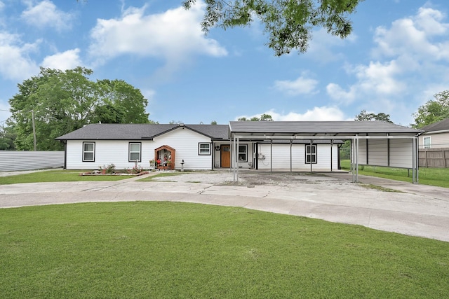 ranch-style house with fence, driveway, and a front lawn