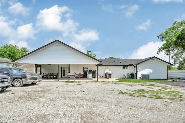 rear view of house with french doors, a patio, and central AC unit