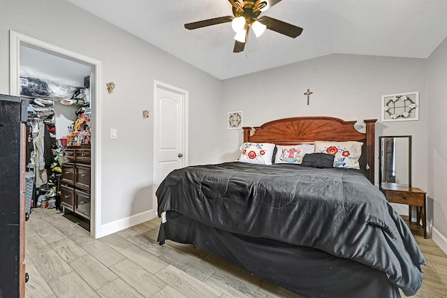bedroom featuring baseboards, vaulted ceiling, ceiling fan, and light wood finished floors