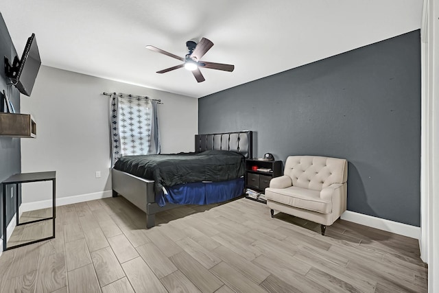 bedroom with baseboards, a ceiling fan, and light wood finished floors
