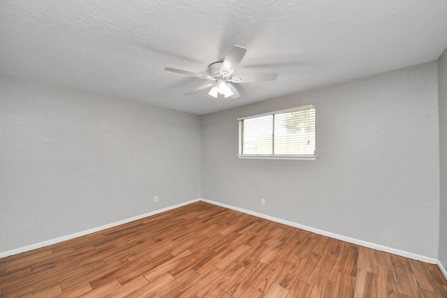 unfurnished room featuring baseboards, ceiling fan, and wood finished floors