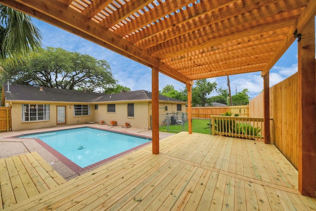 view of pool featuring a pergola, a fenced in pool, a wooden deck, and a fenced backyard