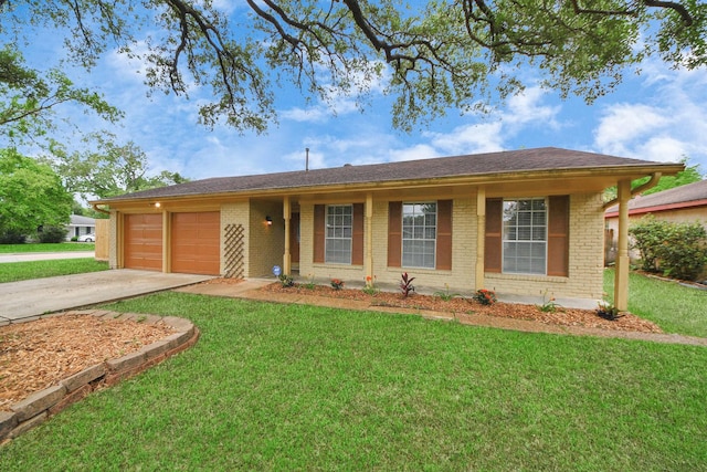 single story home with brick siding, a garage, a front lawn, and concrete driveway
