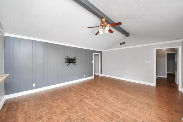 interior space featuring visible vents, wood finished floors, baseboards, vaulted ceiling with beams, and a ceiling fan