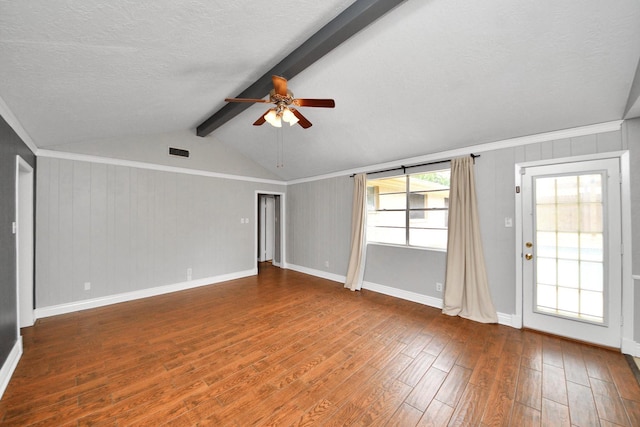 unfurnished living room with lofted ceiling with beams, a ceiling fan, wood finished floors, and visible vents