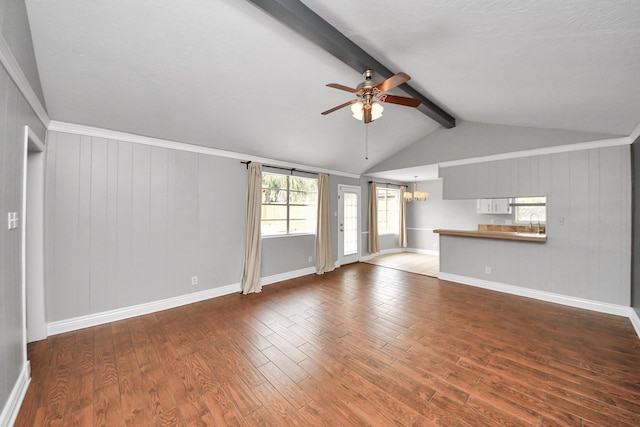 unfurnished living room with ceiling fan, lofted ceiling with beams, a sink, baseboards, and wood finished floors