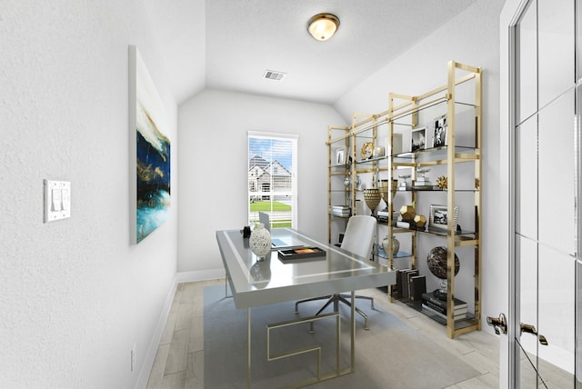 office area with visible vents, baseboards, and lofted ceiling