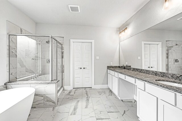 full bathroom with a sink, a stall shower, and visible vents